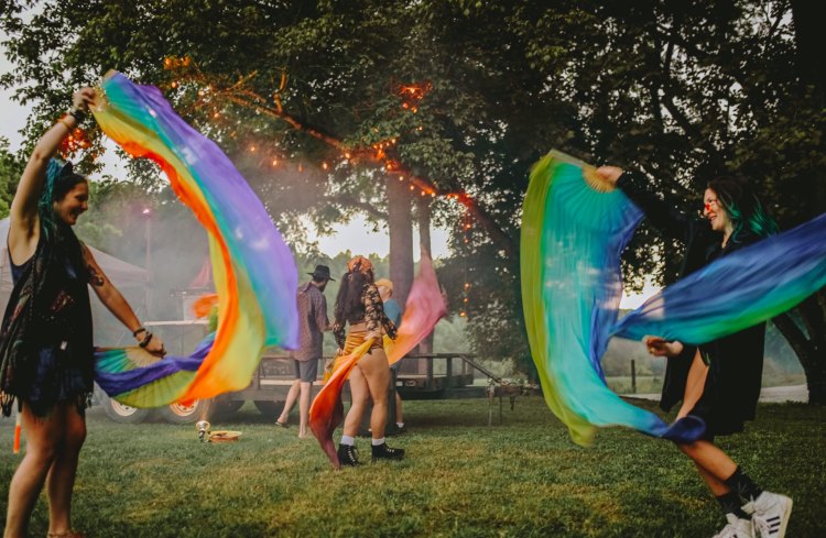Rainbow and other flags flowing in the air at the 2021 "Mini-Roo," an event hosted by the former Bonnaroovian of the year, Lindsey Huffhines, on his property near Winchester, TN.